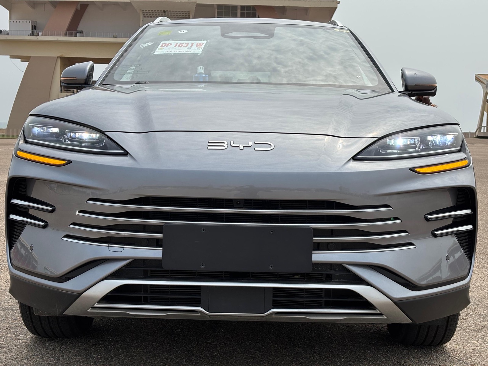 Silver 2025 BYD Song Plus SUV at Independence Square in Accra, Ghana — front view of the Transparent Rentals vehicle used for car hire with a professional driver