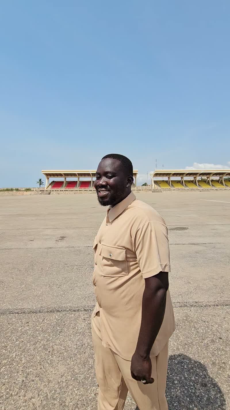 Theo, a professional driver with Transparent Rentals in Accra, standing beside a vehicle